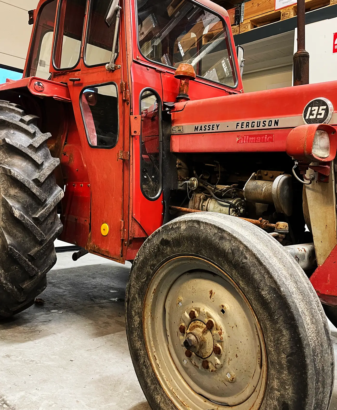 En Massey Ferguson 135 står parkeret på et værksted.