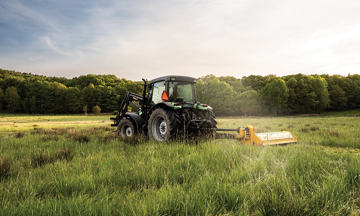 A picture of a Deutz tractor in a summer meadow